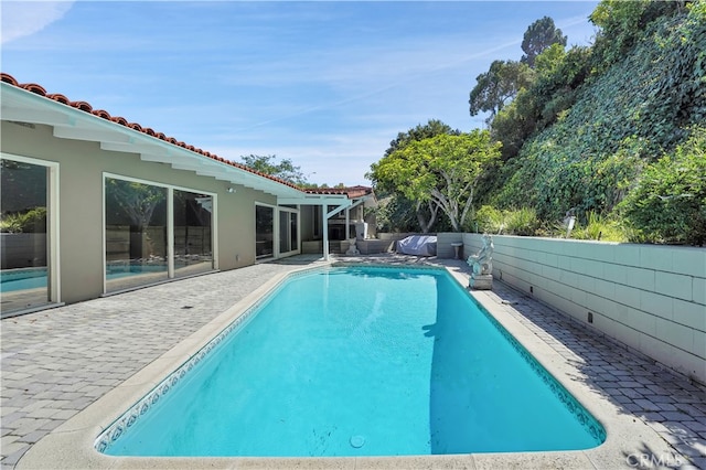 view of swimming pool featuring a patio