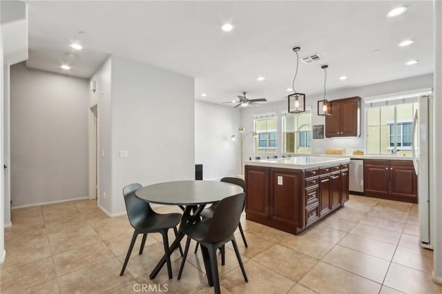 kitchen with ceiling fan, hanging light fixtures, white refrigerator, stainless steel dishwasher, and a center island