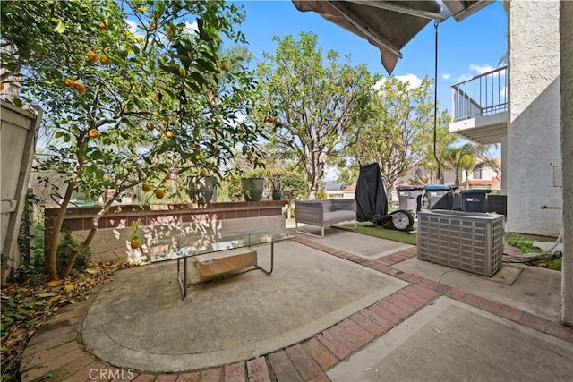 view of patio featuring a balcony