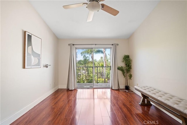 unfurnished room featuring a ceiling fan, baseboards, and wood finished floors