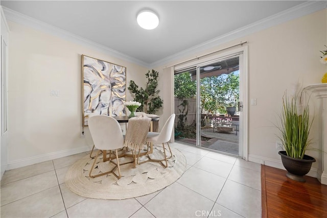 dining space with light tile patterned floors, baseboards, and ornamental molding