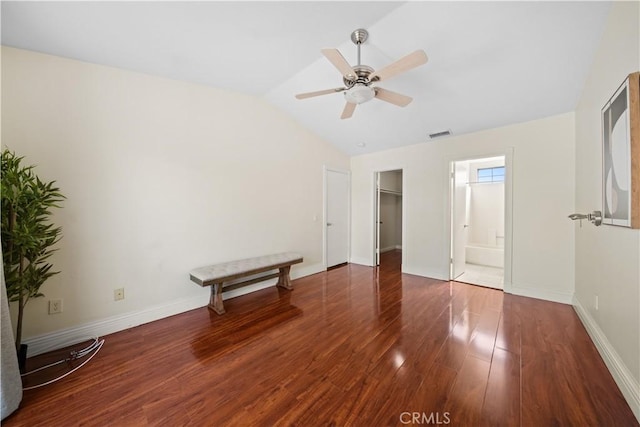 unfurnished bedroom featuring lofted ceiling, wood finished floors, visible vents, and baseboards