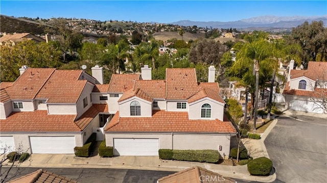 birds eye view of property with a residential view and a mountain view