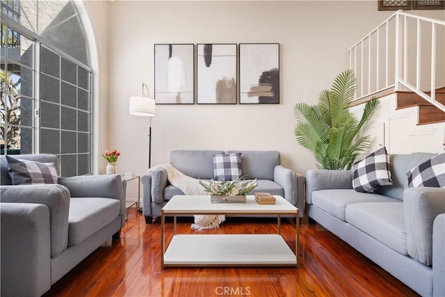 living room featuring stairs and wood finished floors