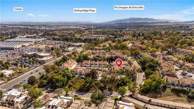 drone / aerial view featuring a residential view and a mountain view