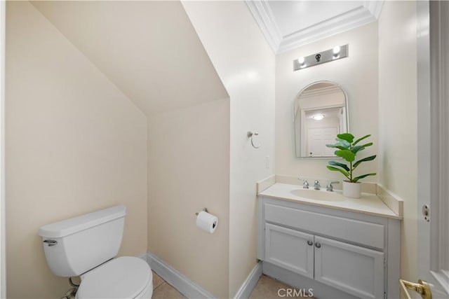 half bath with toilet, baseboards, crown molding, and vanity