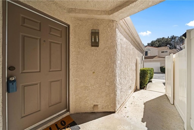 property entrance with stucco siding