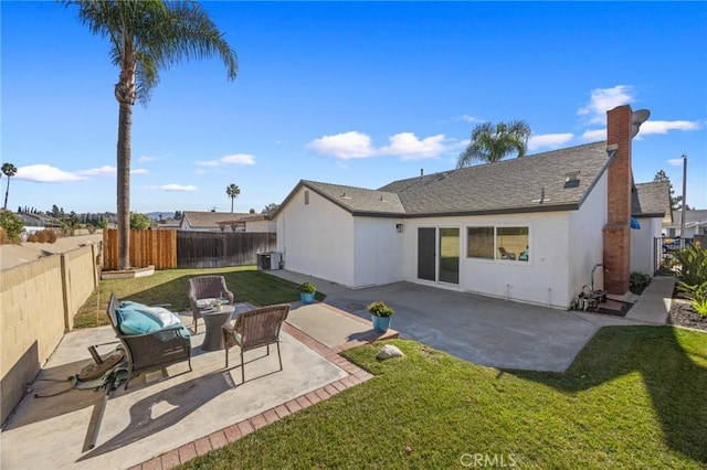 rear view of house featuring a patio area, outdoor lounge area, and a lawn