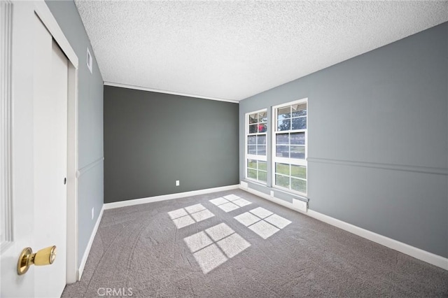 unfurnished bedroom featuring a closet, a textured ceiling, and carpet flooring