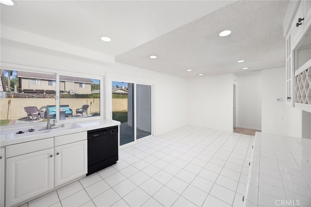 kitchen with a textured ceiling, white cabinets, dishwasher, sink, and light tile patterned floors