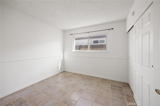 empty room featuring a textured ceiling