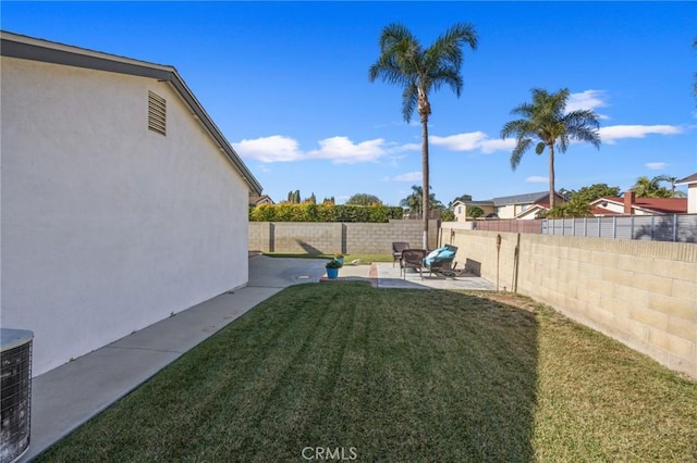 view of yard with central AC unit and a patio area