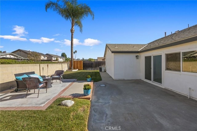 view of yard with cooling unit, an outdoor living space, and a patio