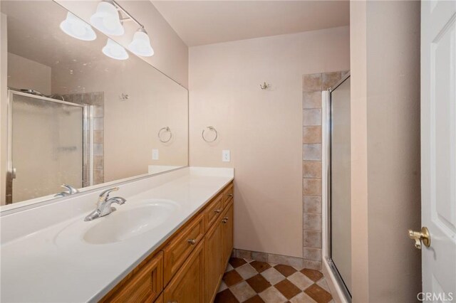 bathroom featuring vanity and a shower with door