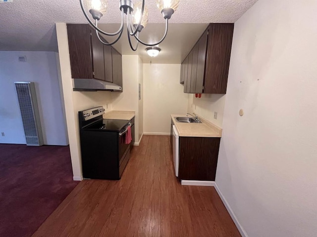 kitchen with a textured ceiling, decorative light fixtures, stainless steel electric stove, and sink