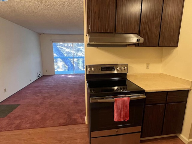 kitchen featuring electric stove, carpet flooring, a textured ceiling, and dark brown cabinetry