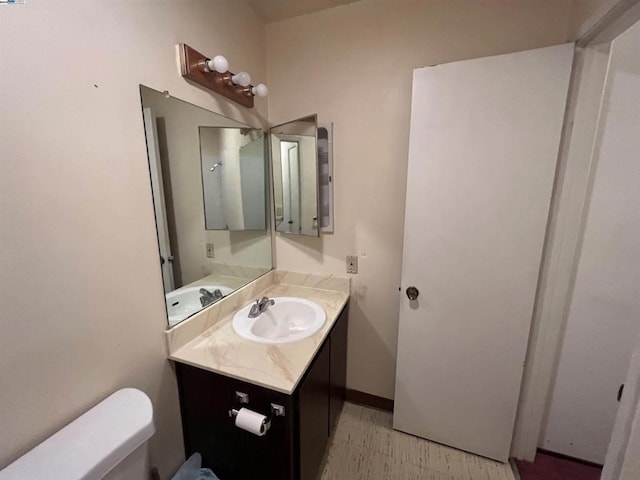 bathroom featuring toilet and vanity