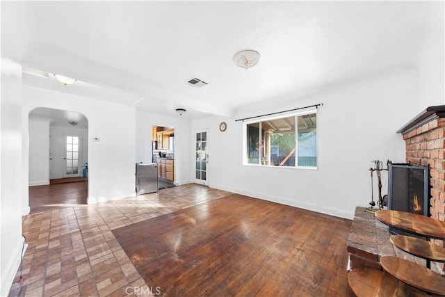 unfurnished living room with a brick fireplace