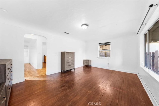 unfurnished living room with wood-type flooring