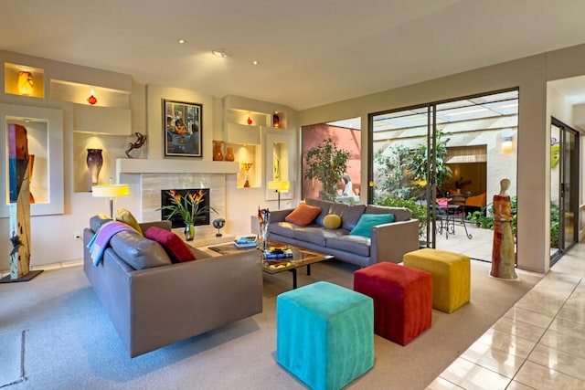 living room with light tile patterned floors and a high end fireplace