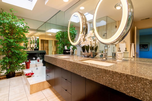 bathroom with shower with separate bathtub, a skylight, tile patterned flooring, and vanity