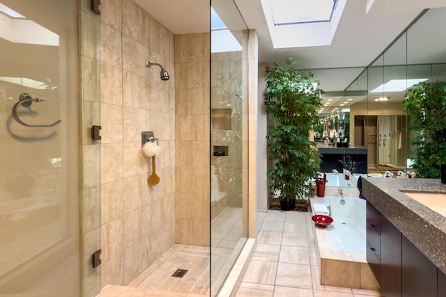 bathroom featuring vanity, a skylight, shower with separate bathtub, and tile patterned flooring