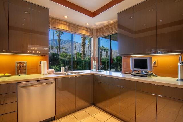 kitchen with stainless steel dishwasher, light tile patterned floors, and sink