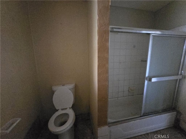 bathroom with toilet and walk in shower