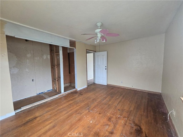 unfurnished bedroom with ceiling fan and wood-type flooring