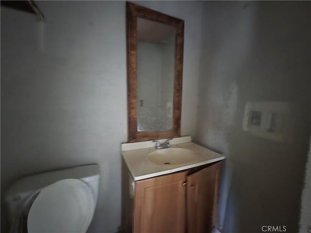 bathroom featuring toilet and vanity