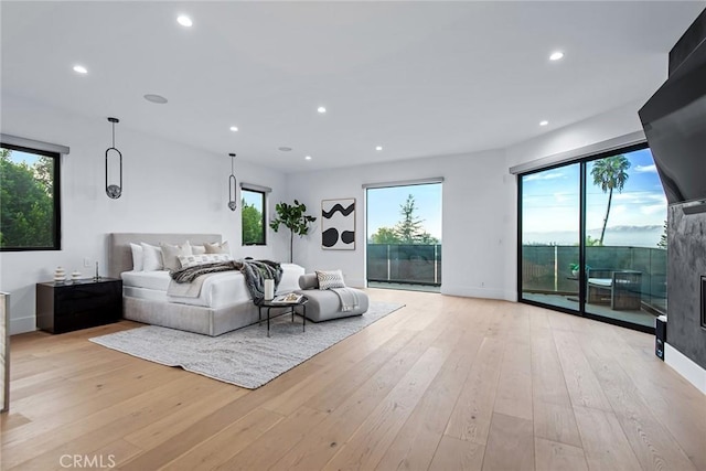 bedroom featuring light hardwood / wood-style flooring and access to outside