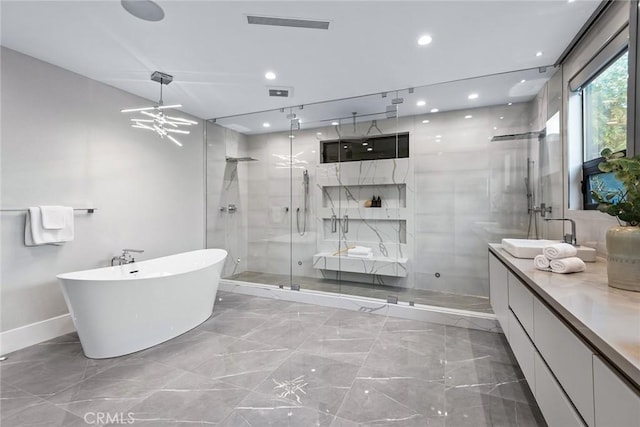 bathroom with vanity and shower with separate bathtub