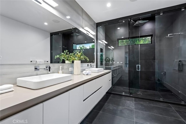 bathroom with tile patterned floors, an enclosed shower, vanity, and a healthy amount of sunlight