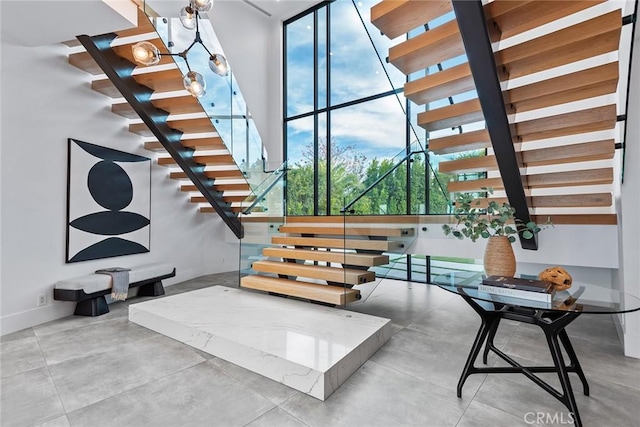 stairs with concrete floors and plenty of natural light