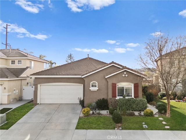 view of front of home with a front lawn and a garage