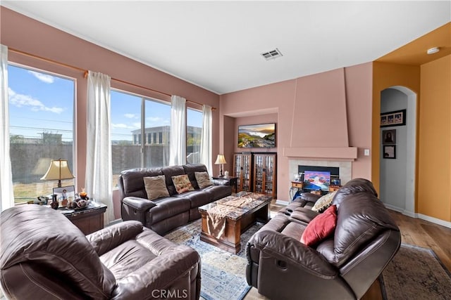 living room with hardwood / wood-style flooring and a tile fireplace