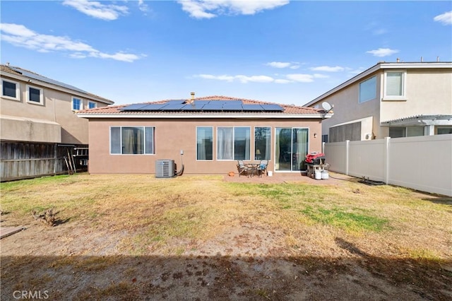 rear view of property featuring central air condition unit, a yard, and a patio