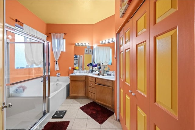 bathroom featuring vanity, tile patterned flooring, and plus walk in shower