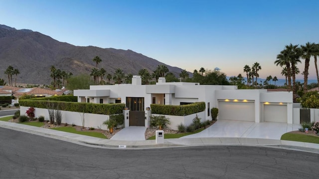 contemporary house with a mountain view and a garage