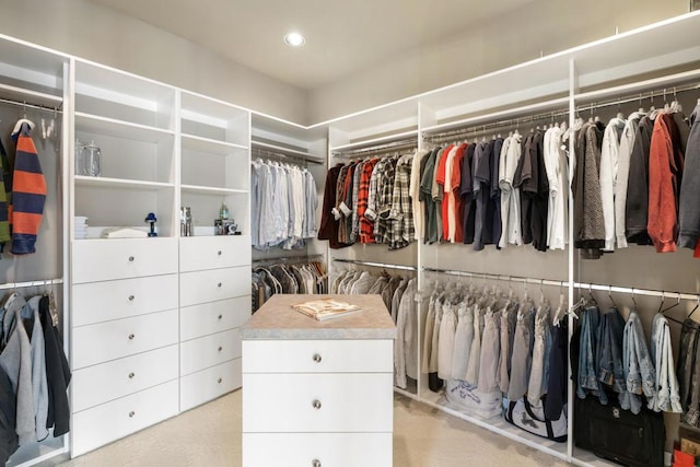 walk in closet featuring light carpet