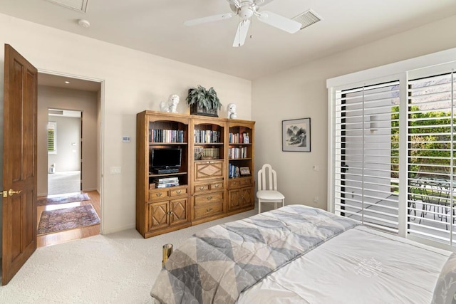 carpeted bedroom featuring ceiling fan and access to exterior