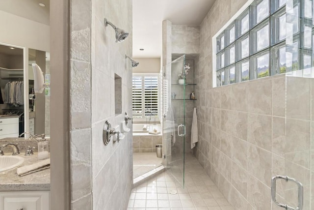 bathroom featuring separate shower and tub, vanity, and tile patterned floors