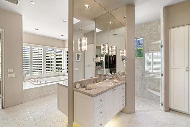 bathroom featuring vanity, a notable chandelier, and plus walk in shower