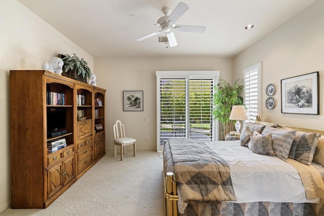 bedroom with ceiling fan and light carpet