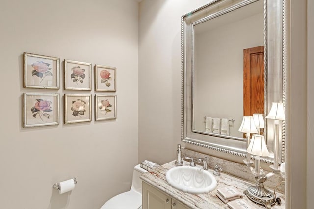 bathroom featuring toilet and vanity