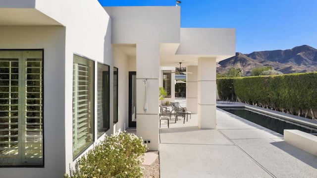 view of patio with a mountain view and a fenced in pool