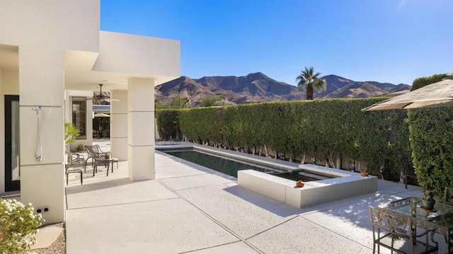 view of patio / terrace with a mountain view and a fenced in pool