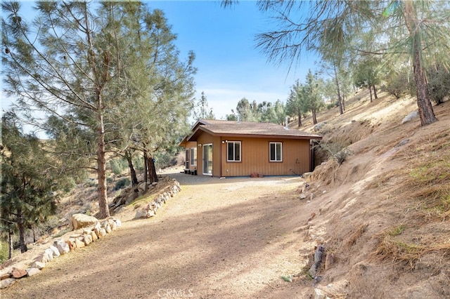 exterior space featuring dirt driveway