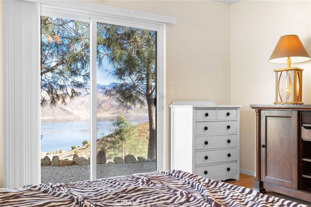 unfurnished bedroom featuring a water view and multiple windows