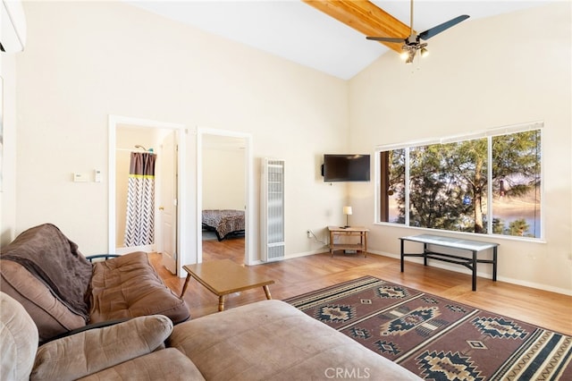 living area with high vaulted ceiling, a ceiling fan, light wood-style flooring, and baseboards